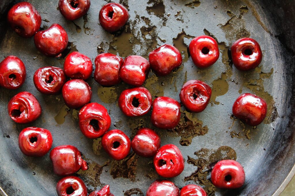 close up of cherries in a cast iron pan