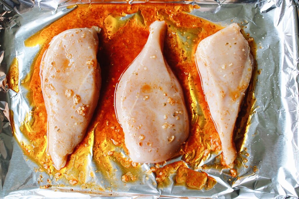 chicken breast with marinade on it