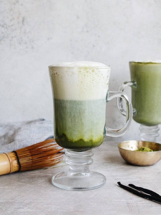 a vanilla matcha latte in a clear mug