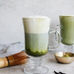 a vanilla matcha latte in a clear mug