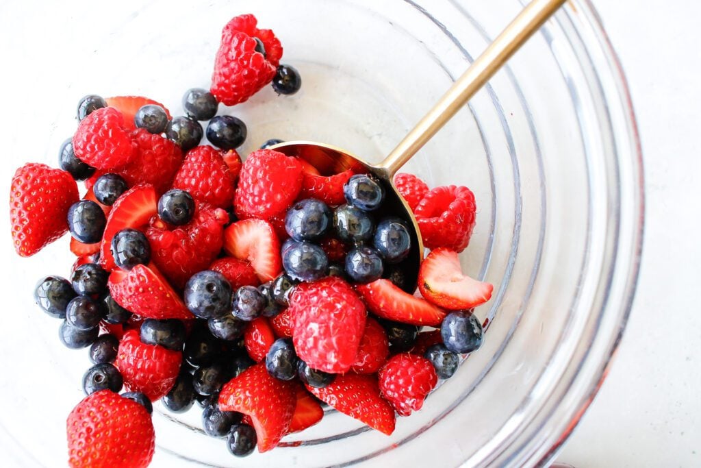 blueberries, strawberries and raspberries in a mixing bowl