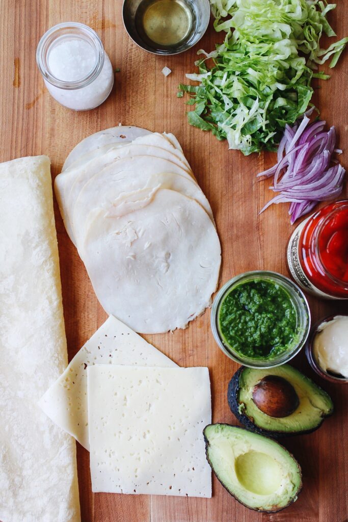 turkey pesto wrap ingredients on a cutting board