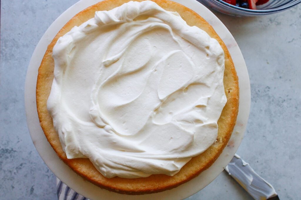 whipped cream spread on top of cake