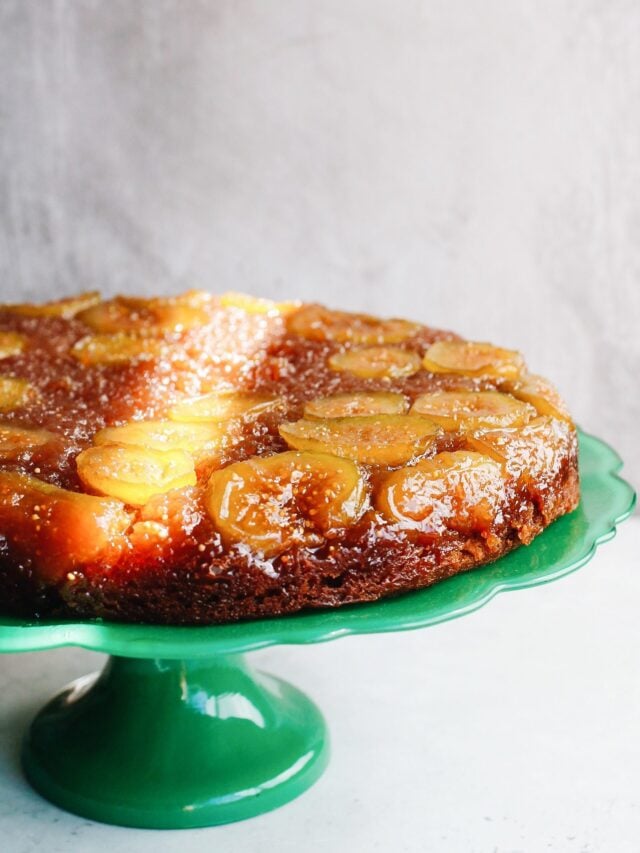 fig and honey cake on a bright green cake stand.