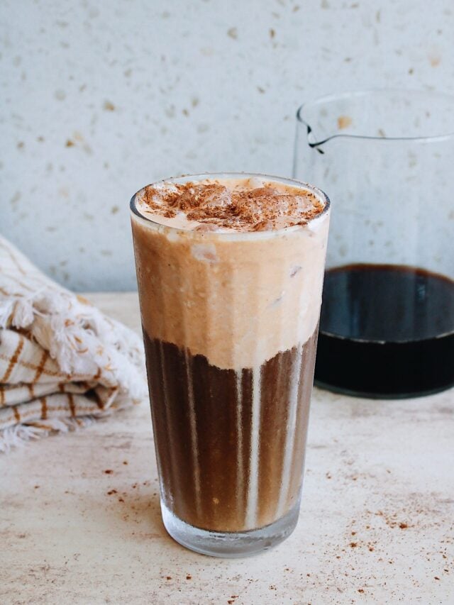 pumpkin cold foam coffee in a clear glass