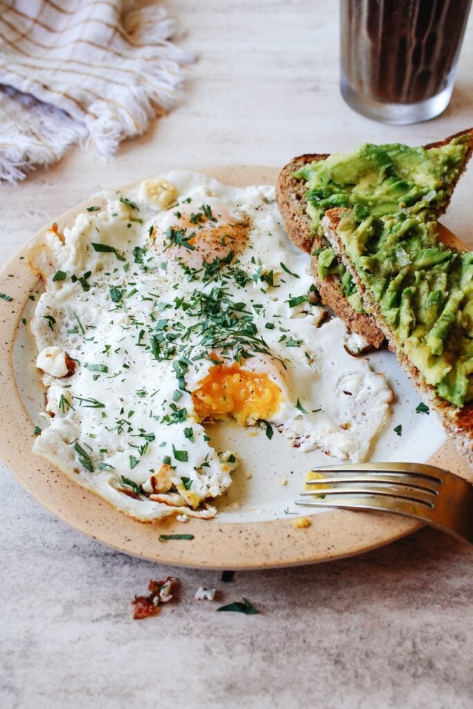 feta fried eggs served with avocado toast on the side