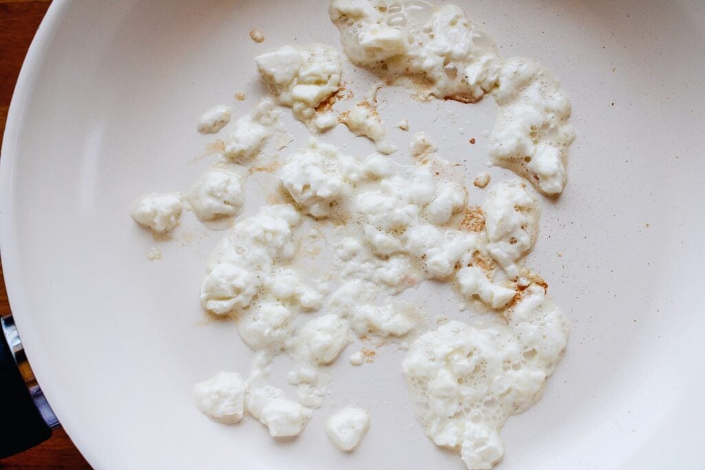 feta melting in the bottom of a nonstick pan