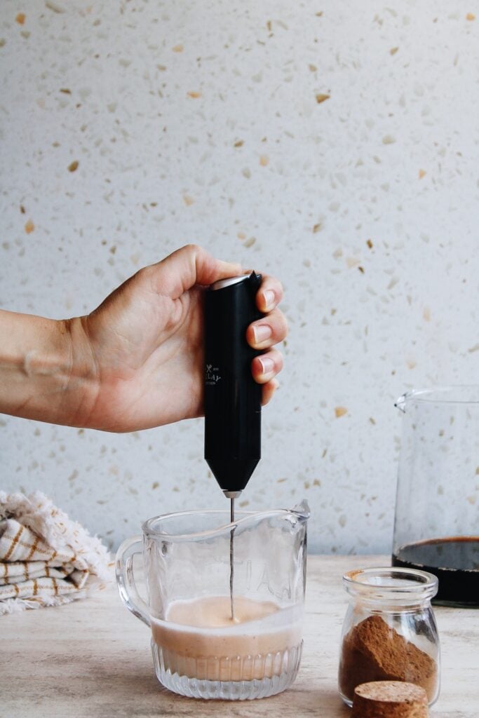 pumpkin cold foam being made with a milk frother