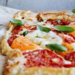 puff pastry tomato tart topped with basil