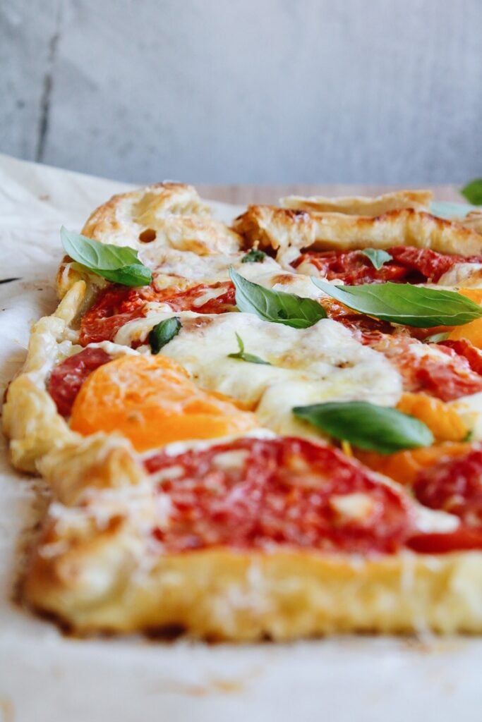 puff pastry tomato tart topped with basil