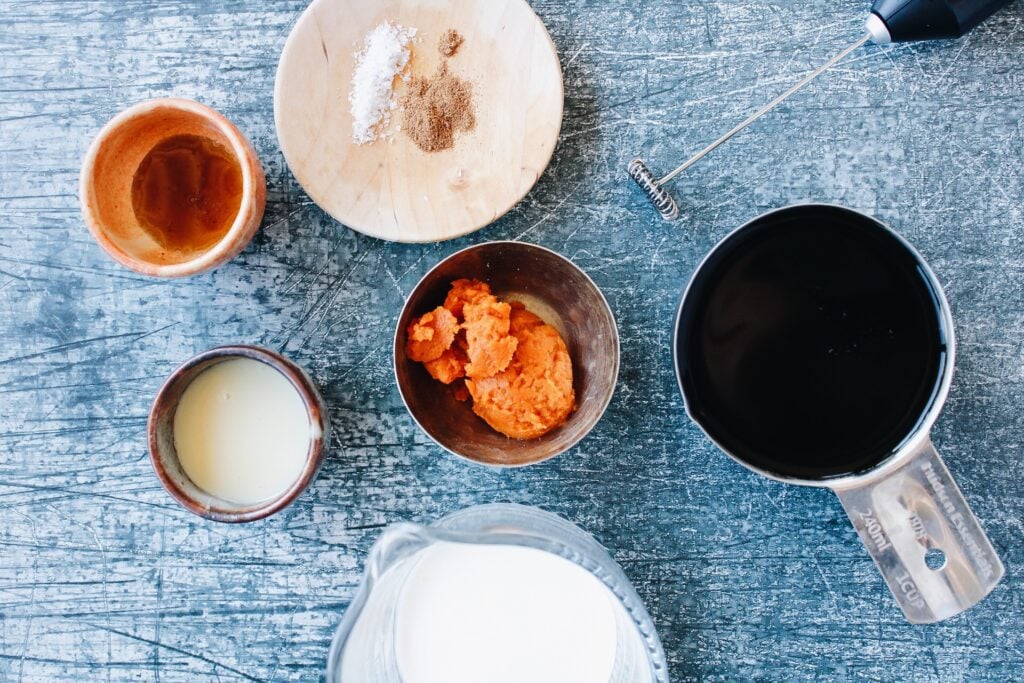 ingredients for pumpkin cold foam on a blue background