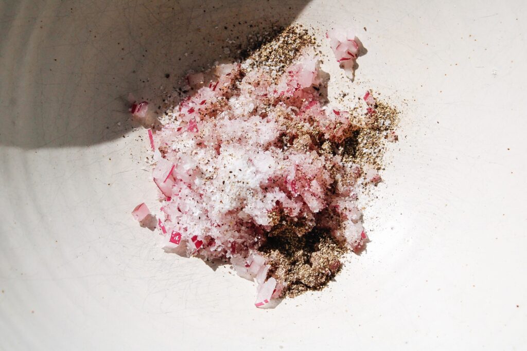 diced red onion with salt and pepper