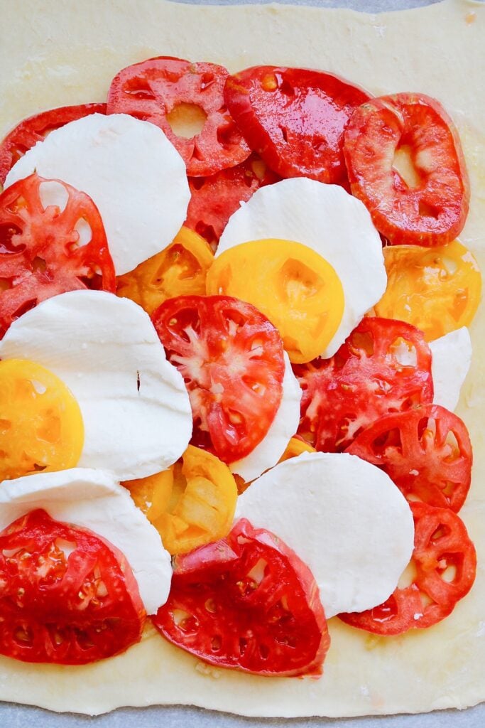 tomato slices and mozzarella slices on puff pastry