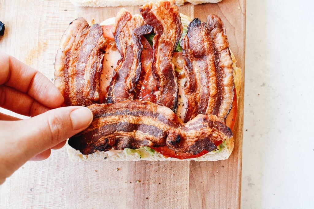 Half bacon strips placed on sandwich horizontally 