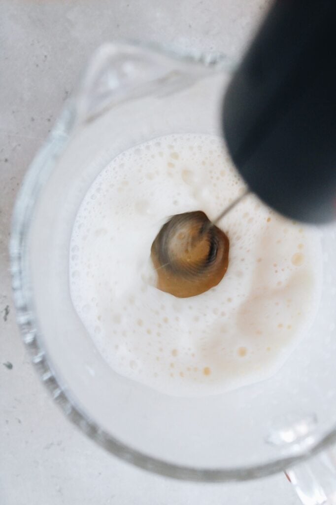 warm milk being frothed with a hand-held milk frother