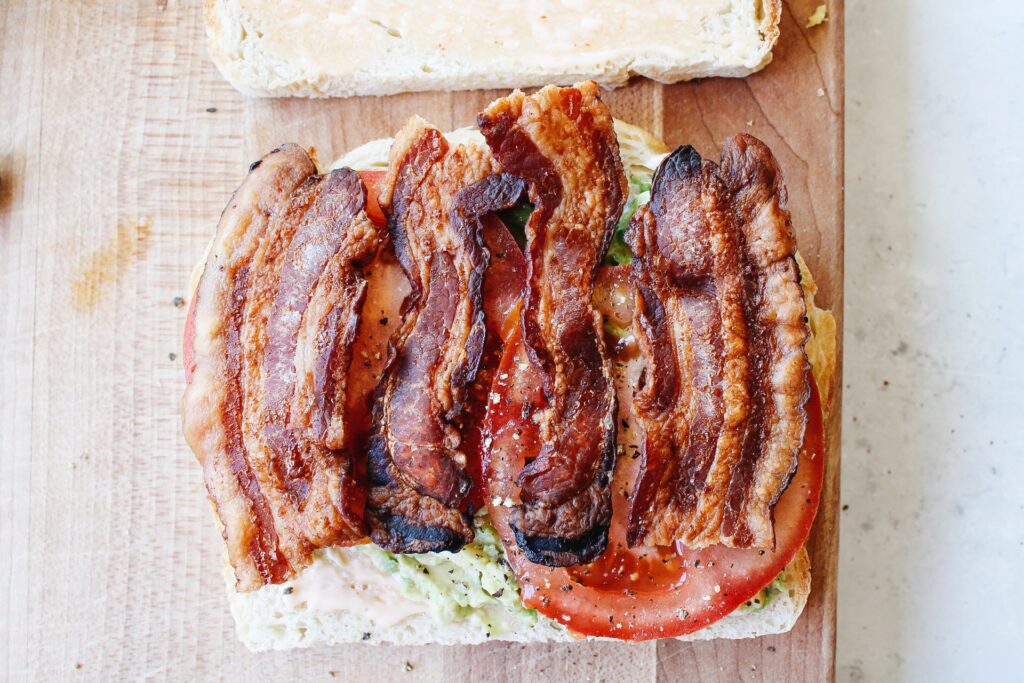 Strips of bacon broken in half and placed on BLT vertically 