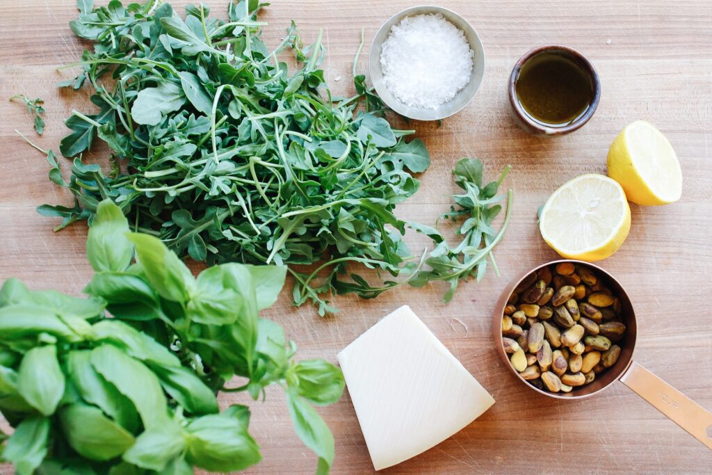 ingredients for pesto without garlic on a wooden cutting board