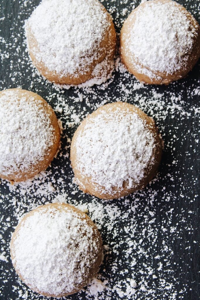 Chai shortbread snowball cookies on a black background