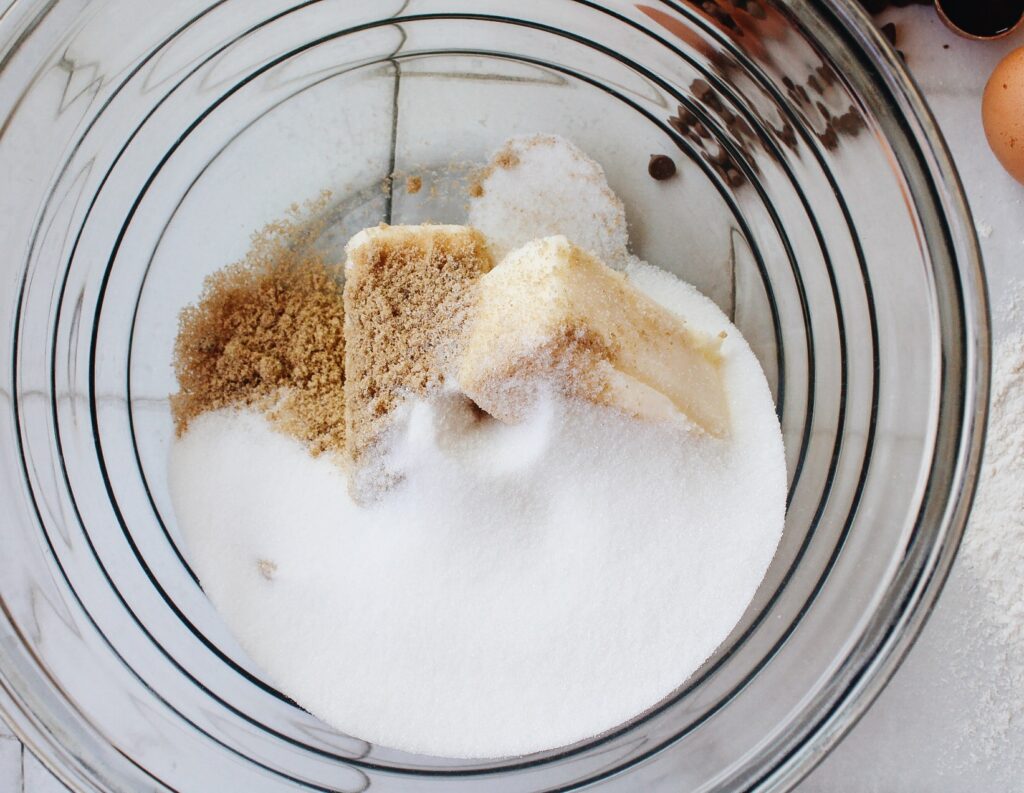 Butter and sugars in a mixing bowl 