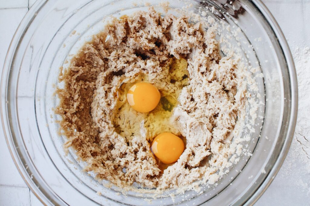 Eggs and vanilla added to creamed butter and sugar 