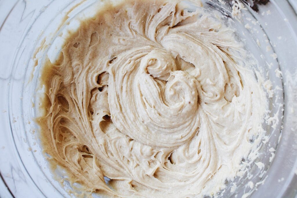 Eggs and vanilla incorporated into beaten butter and sugar for carob cookies