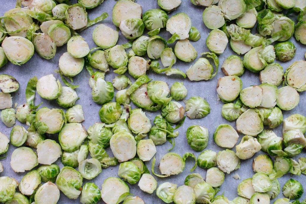 sliced brussel sprouts spread evenly on baking sheet