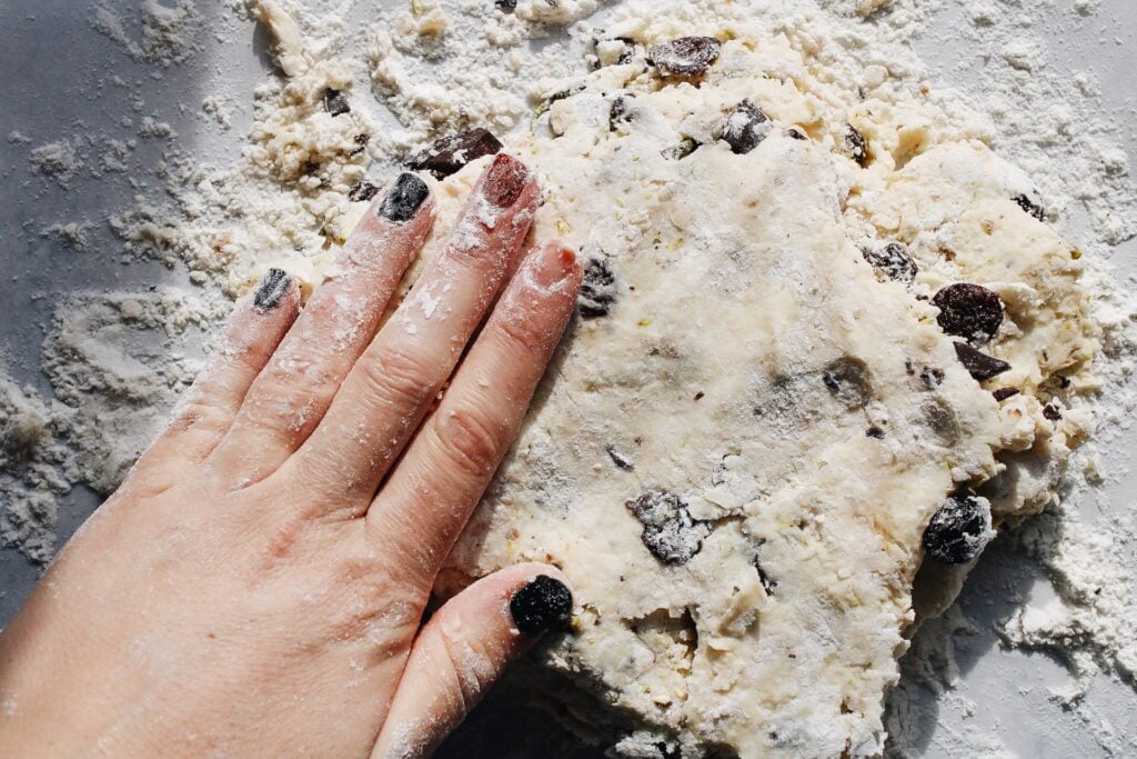 scone dough pressed down to knead