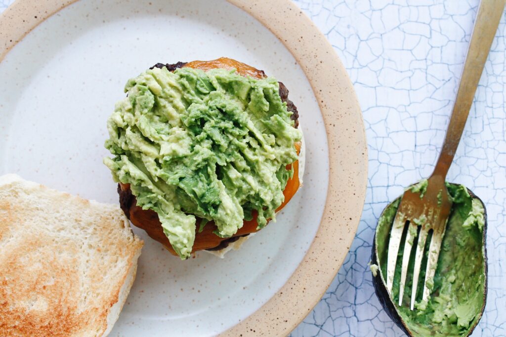 Mashed avocado on top of burger