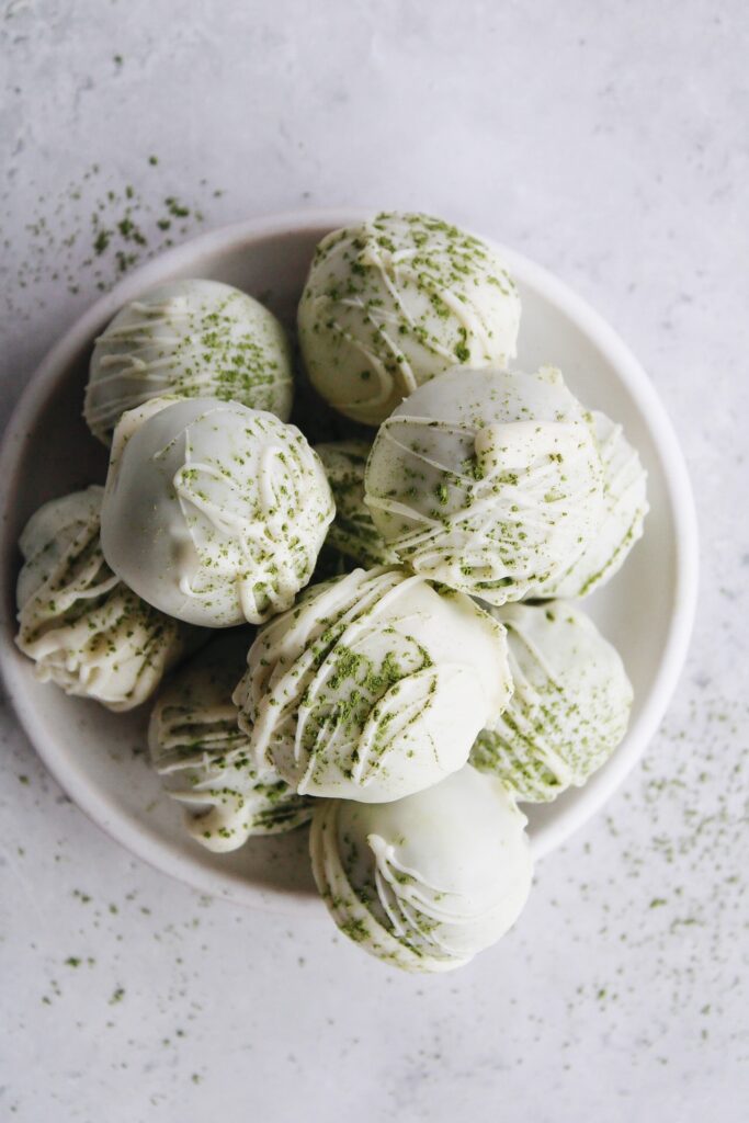 matcha truffles made with white chocolate on a white plate