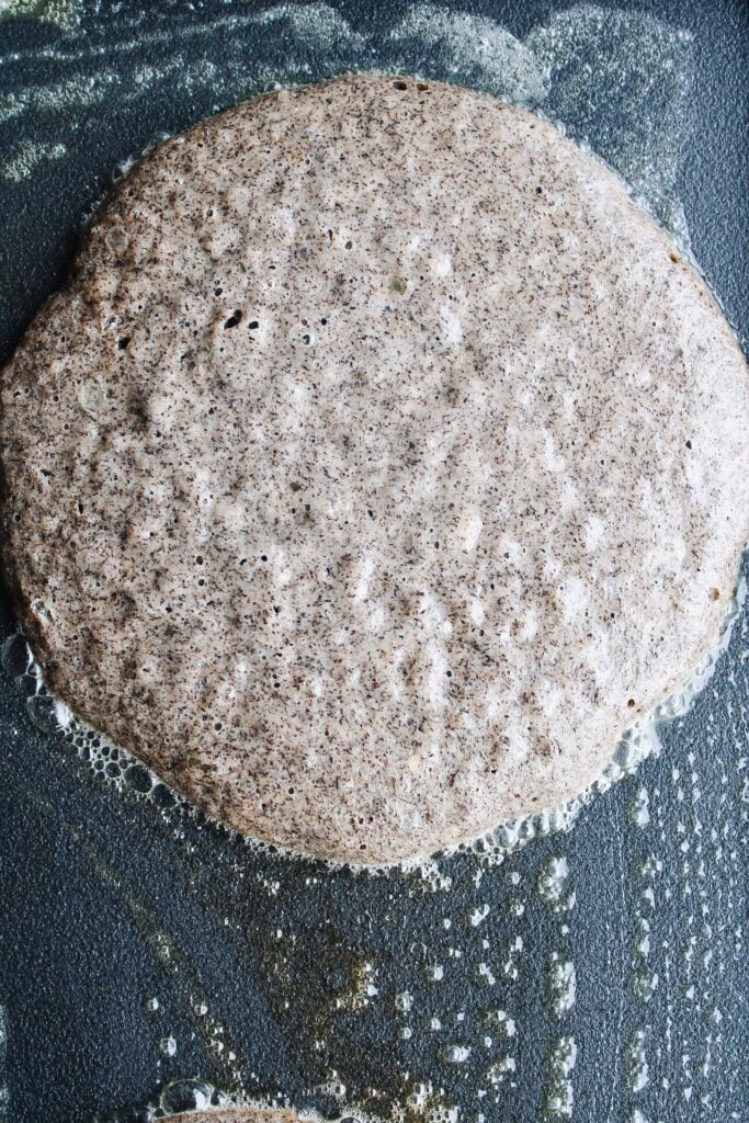 close up of air bubbles on a pancake when ready to flip