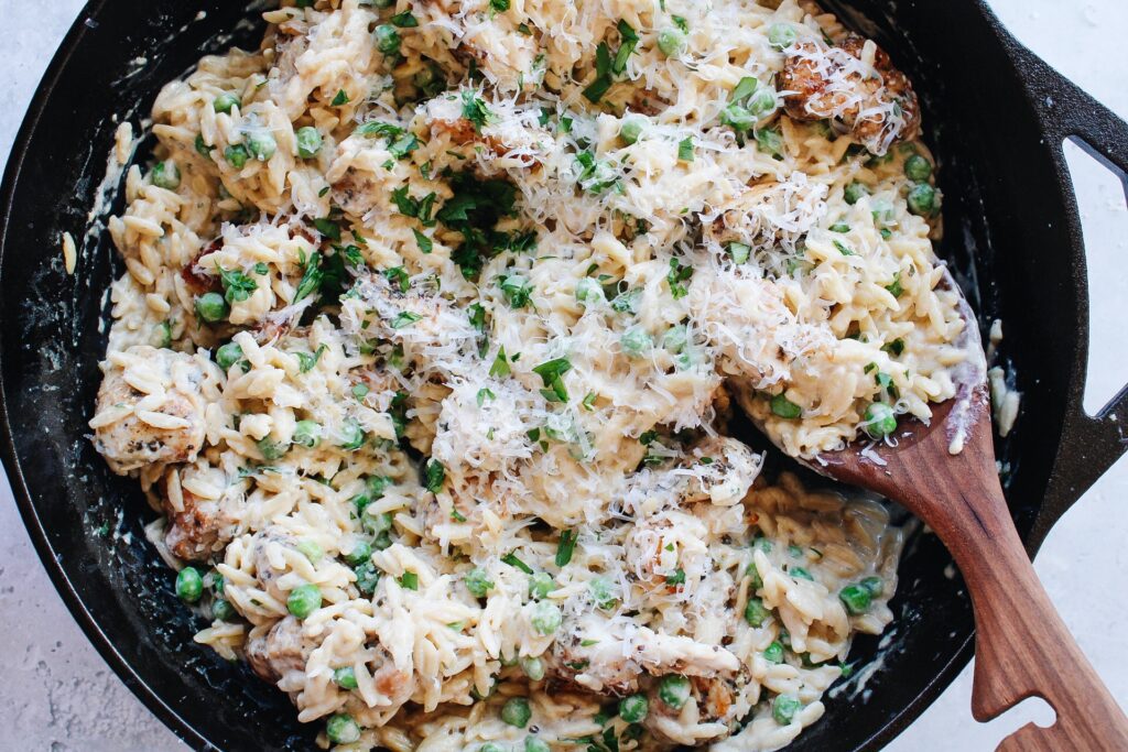 boursin orzo with chicken in a cast iron skillet