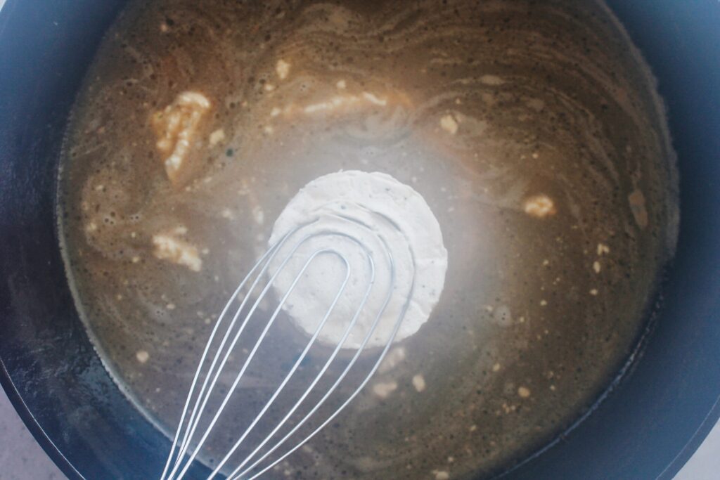 boursin cheese added to skillet with chicken broth