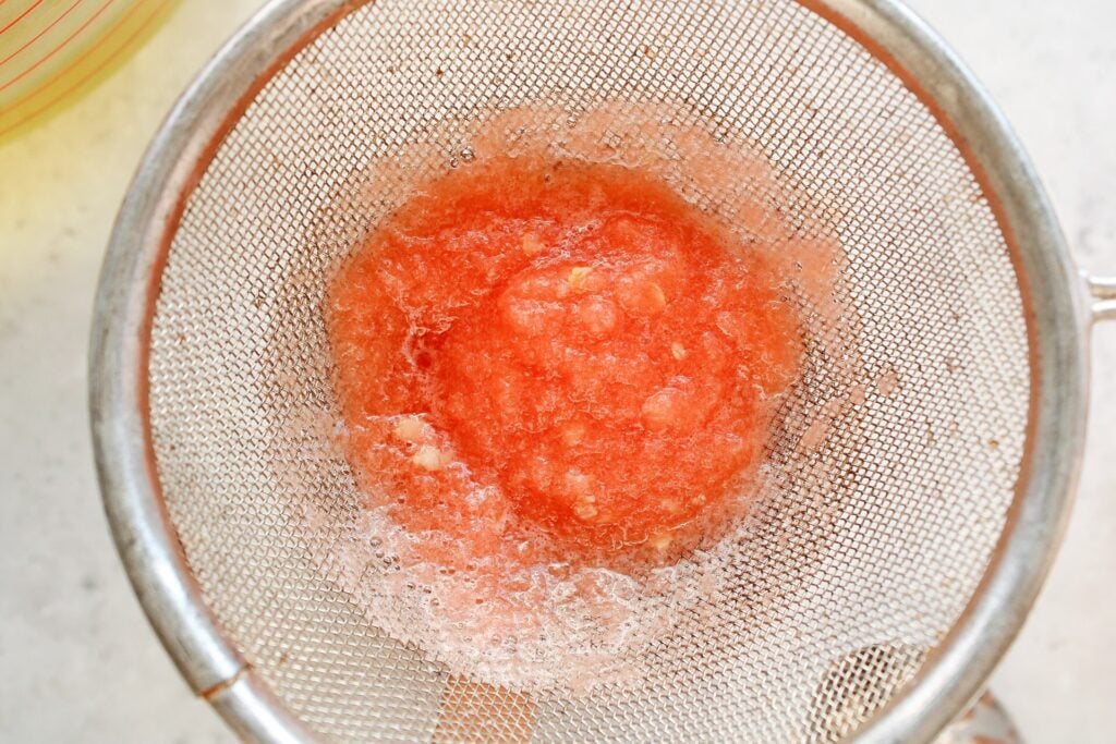 blended watermelon being strained