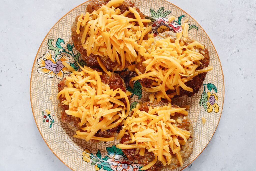 chicken burgers on a plate topped with cheese