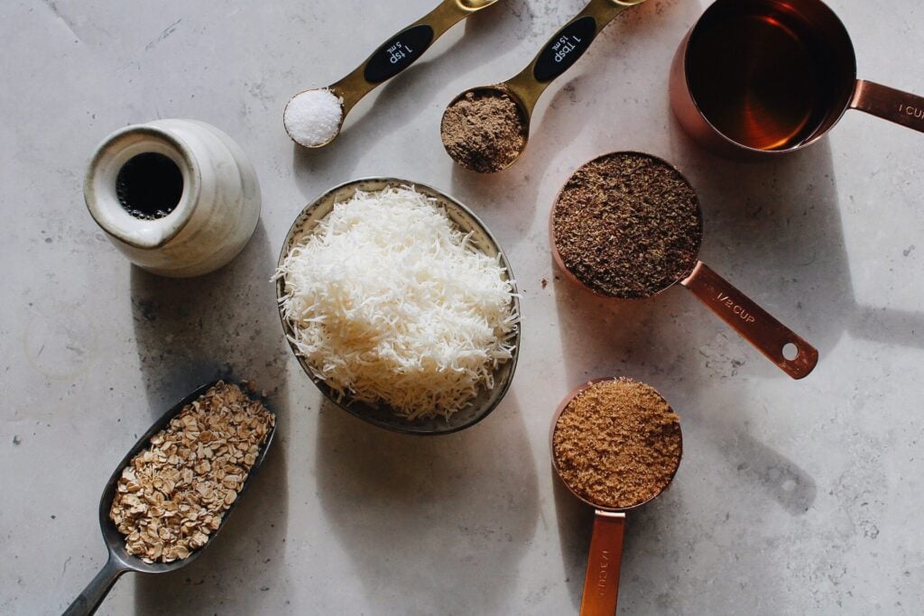 ingredients for coconut cardamom granola on a gray background