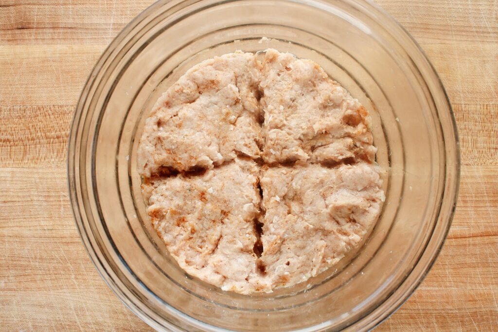 ground chicken mixture in a bowl scored into four even sections