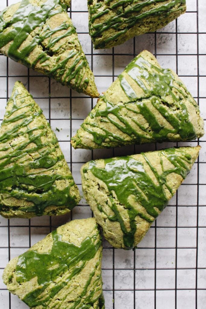 matcha scones with matcha glaze on a cooling rack