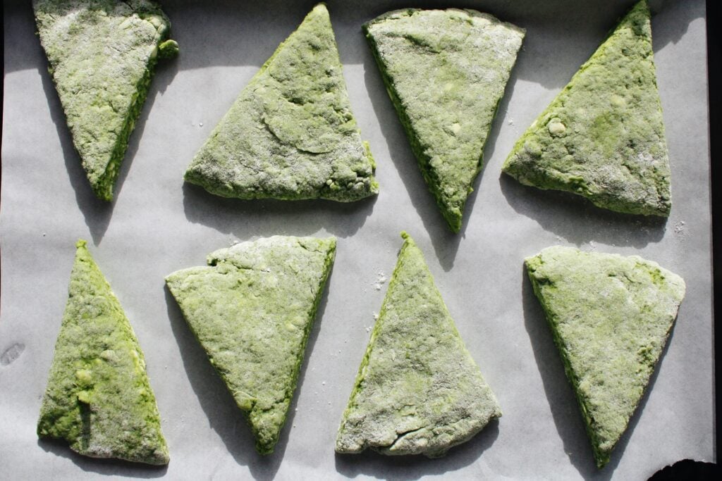 matcha scones on a baking sheet lined with parchment