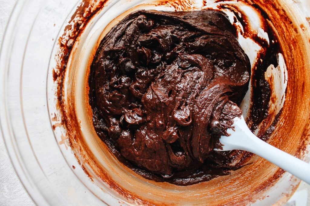 brownie batter in a glass mixing bowl