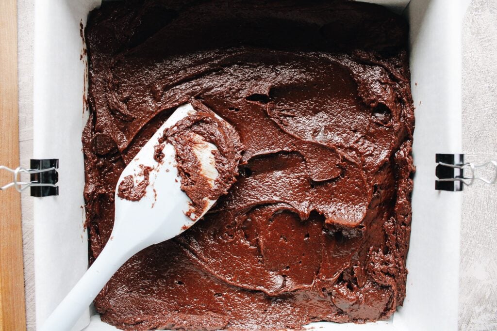 brownie batter spread in a baking pan